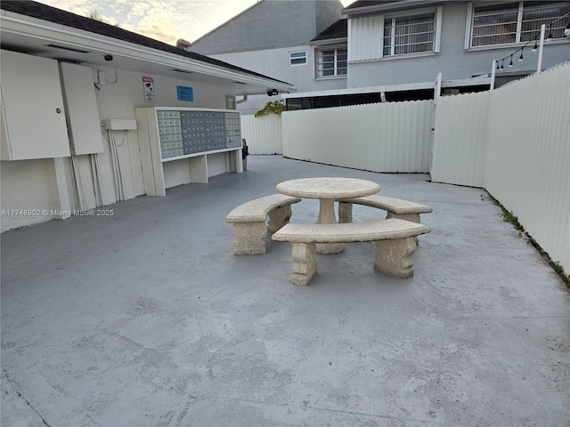 exterior space with fence and mail area