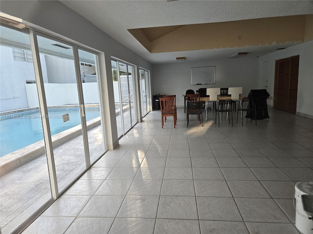 dining space featuring a textured ceiling and light tile patterned floors