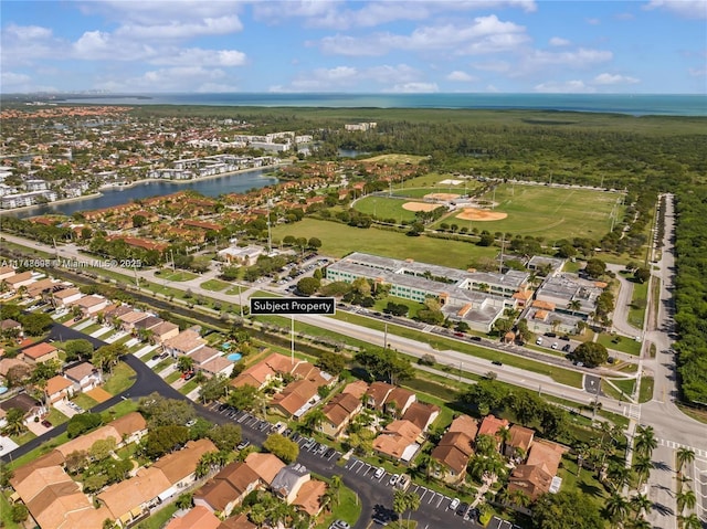 drone / aerial view featuring a water view and a residential view