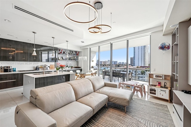 living area with a wall of windows, a view of city, and light tile patterned floors