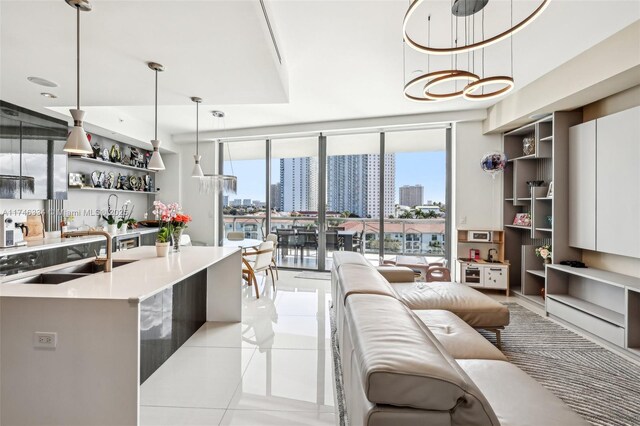 living area featuring a healthy amount of sunlight, floor to ceiling windows, a city view, and light tile patterned flooring
