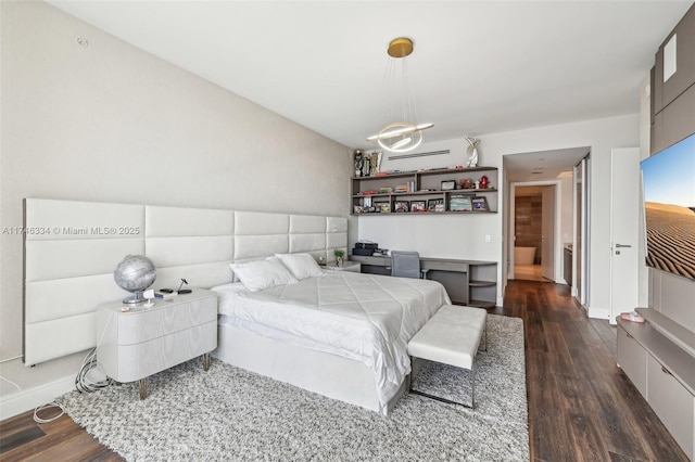 bedroom with dark wood-style flooring and baseboards