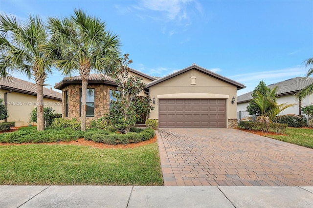 view of front of property with stone siding, an attached garage, decorative driveway, a front lawn, and stucco siding