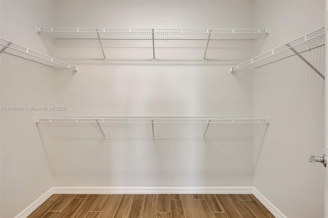 spacious closet with wood finished floors