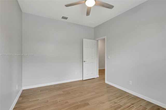 unfurnished room with baseboards, visible vents, ceiling fan, and light wood finished floors