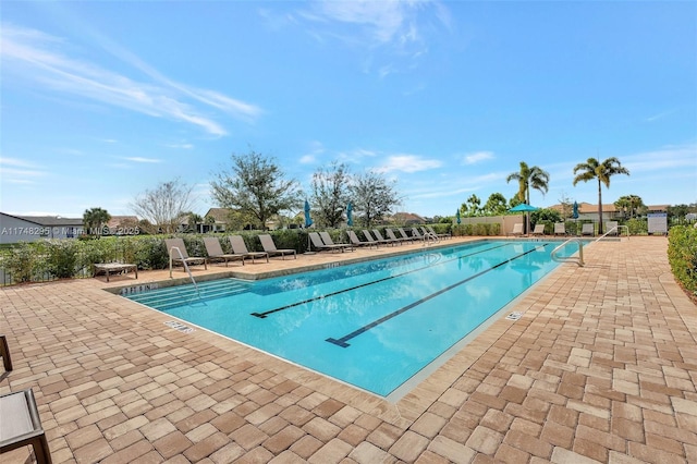 community pool featuring a patio area and fence