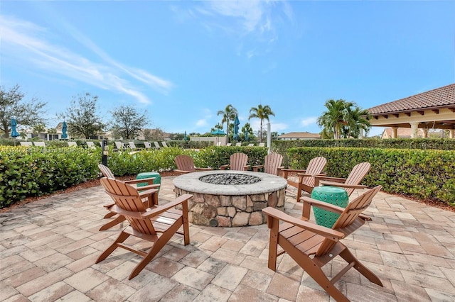 view of patio featuring fence and a fire pit