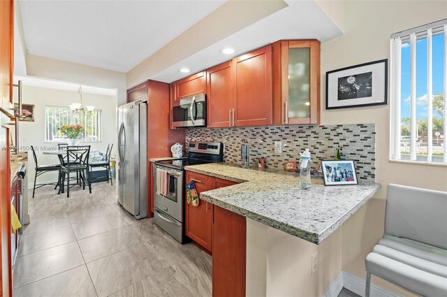 801 Sw 141 101O, Pembroke Pines, FL 33027 - kitchen featuring backsplash, stainless steel appliances, and a wealth of natural light