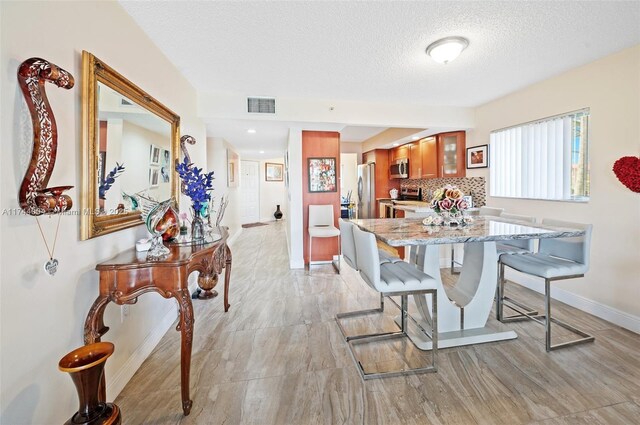 801 Sw 141 101O, Pembroke Pines, FL 33027 - dining area with baseboards, a textured ceiling, and visible vents