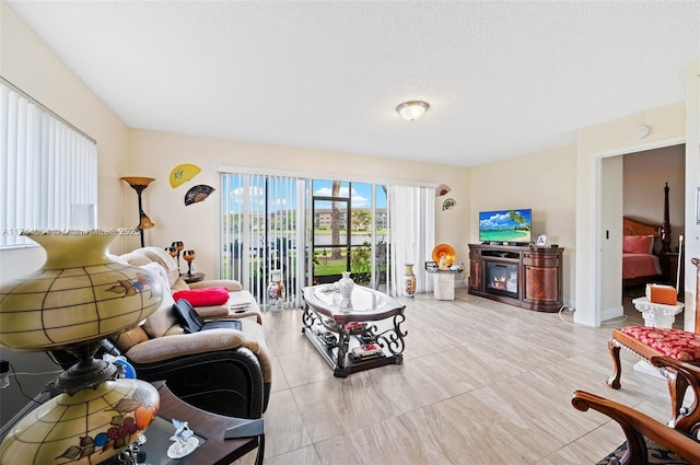 801 Sw 141 101O, Pembroke Pines, FL 33027 - living area with a glass covered fireplace and light tile patterned flooring