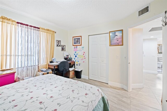 801 Sw 141 101O, Pembroke Pines, FL 33027 - bedroom featuring baseboards, a textured ceiling, and visible vents