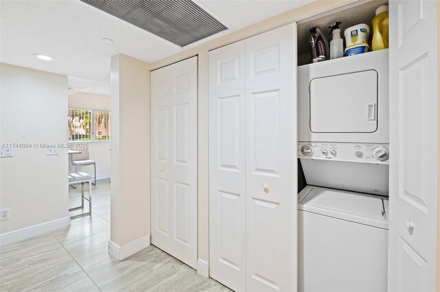 801 Sw 141 101O, Pembroke Pines, FL 33027 - laundry room featuring laundry area, stacked washer / dryer, visible vents, baseboards, and recessed lighting