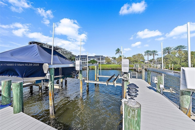 dock area with a water view and boat lift