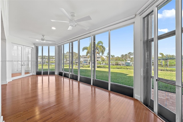 unfurnished sunroom featuring a ceiling fan