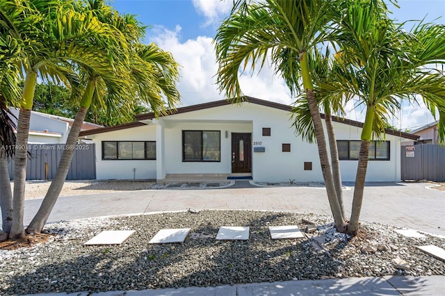 2510 NE 215th St, Miami, FL 33180 - view of front of house with stucco siding and fence