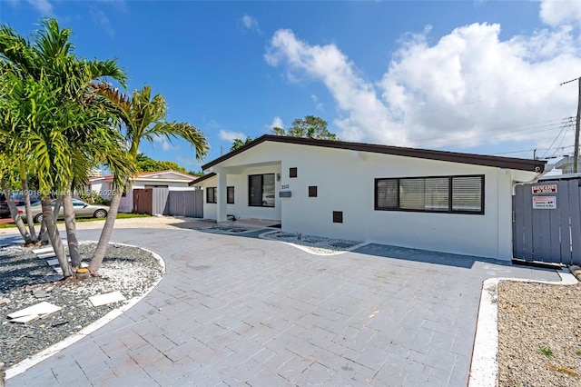 2510 NE 215th St, Miami, FL 33180 - ranch-style house featuring fence, a patio area, and stucco siding