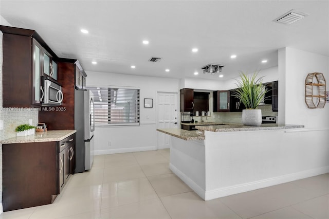 2510 NE 215th St, Miami, FL 33180 - kitchen with backsplash, appliances with stainless steel finishes, and visible vents