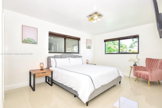 bedroom featuring light tile patterned flooring and baseboards