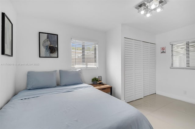 2510 NE 215th St, Miami, FL 33180 - bedroom featuring baseboards and light tile patterned floors
