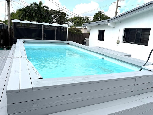 view of swimming pool with a fenced in pool and fence