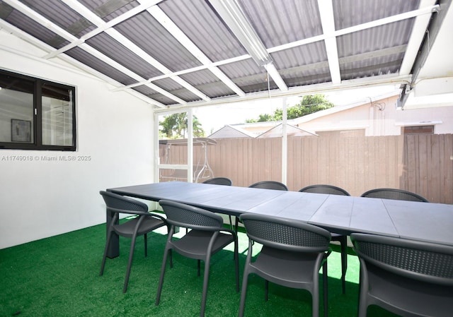 view of patio featuring outdoor dining area and fence