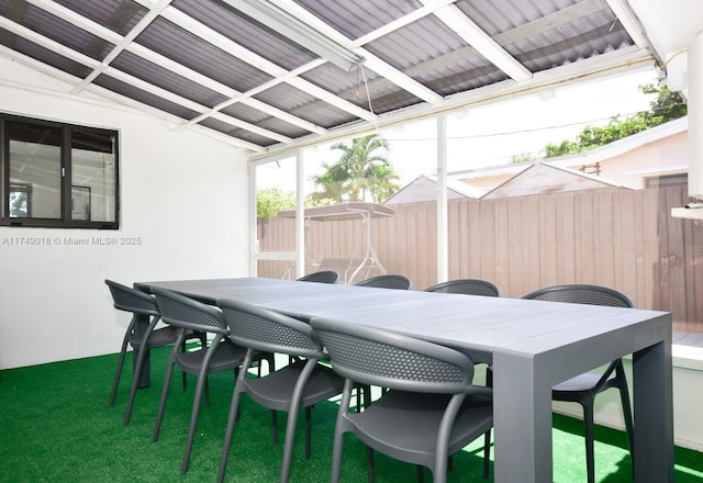 view of patio with outdoor dining space and fence