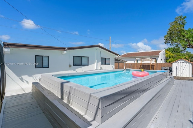 2510 NE 215th St, Miami, FL 33180 - view of pool featuring fence, a deck, an outbuilding, and a shed