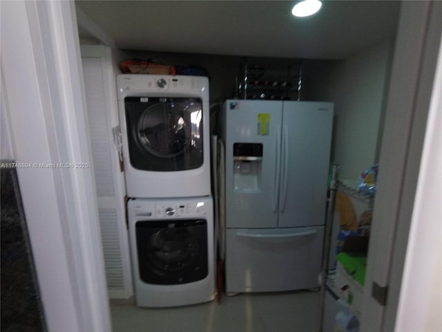 washroom featuring laundry area and stacked washing maching and dryer