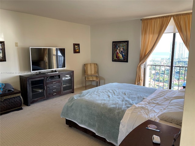 bedroom with access to outside and light colored carpet