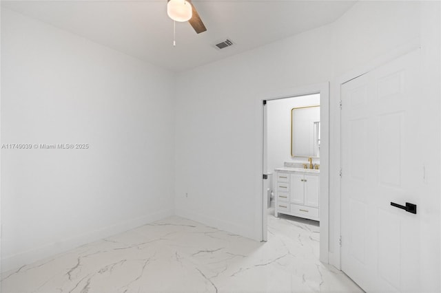 bedroom featuring marble finish floor, a sink, visible vents, and baseboards