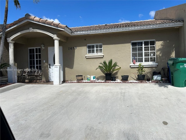 exterior space featuring a patio area and stucco siding