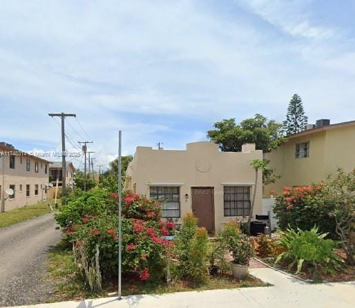 pueblo revival-style home featuring stucco siding