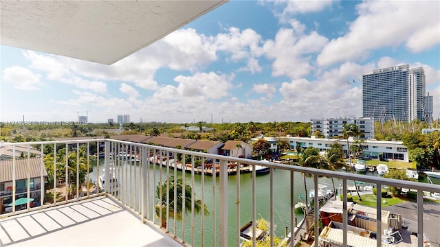 balcony featuring a water view and a city view