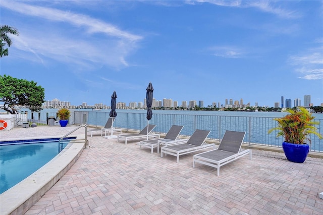 pool featuring a view of city and a patio area