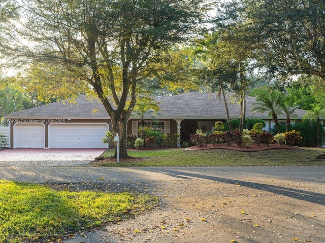 single story home featuring driveway and a garage