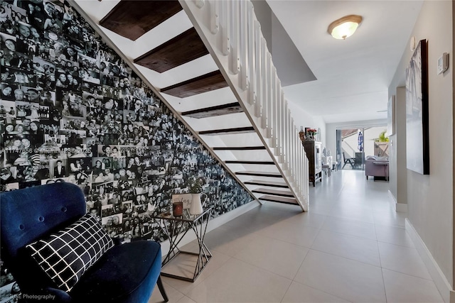 stairs featuring baseboards and tile patterned floors