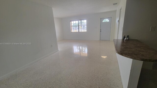 11715 SW 183rd St, Miami, FL 33177 - entryway featuring a textured ceiling and baseboards