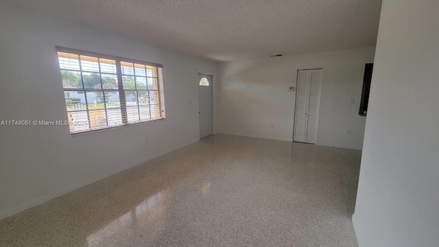 11715 SW 183rd St, Miami, FL 33177 - empty room featuring a textured ceiling and speckled floor