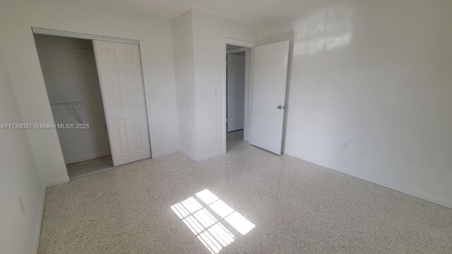 11715 SW 183rd St, Miami, FL 33177 - unfurnished bedroom with speckle patterned floor and a closet