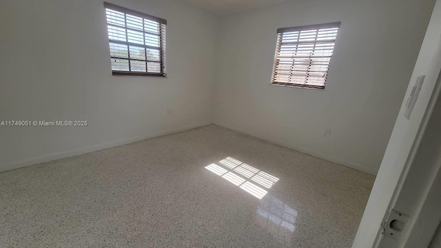 11715 SW 183rd St, Miami, FL 33177 - spare room with speckle patterned floor and baseboards