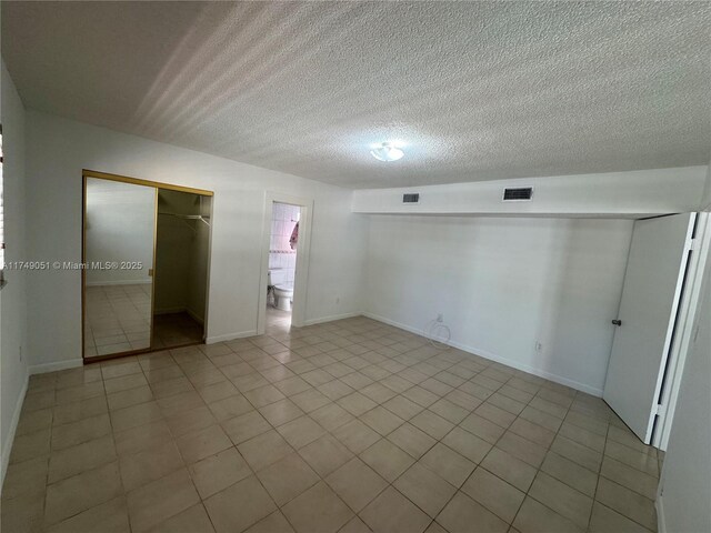 11715 SW 183rd St, Miami, FL 33177 - unfurnished room featuring a textured ceiling, tile patterned flooring, and baseboards