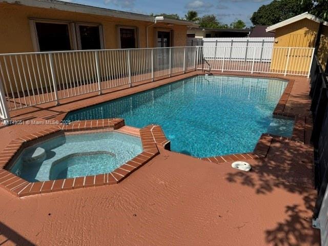 11715 SW 183rd St, Miami, FL 33177 - view of pool with a fenced backyard and a pool with connected hot tub