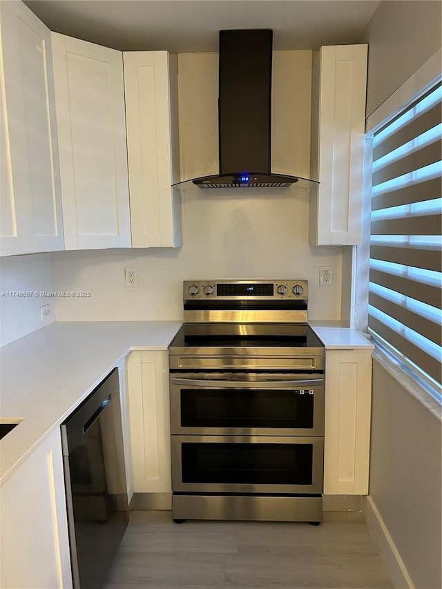 22511 SW 88th Pl, Cutler Bay, FL 33190 - kitchen featuring light countertops, white cabinetry, wall chimney range hood, double oven range, and dishwasher