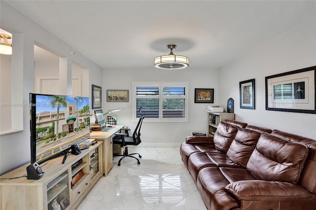 office space featuring baseboards and marble finish floor