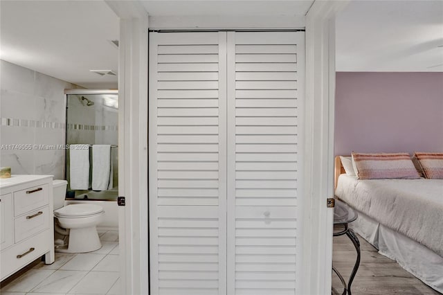 interior space featuring light tile patterned floors, visible vents, and ensuite bathroom