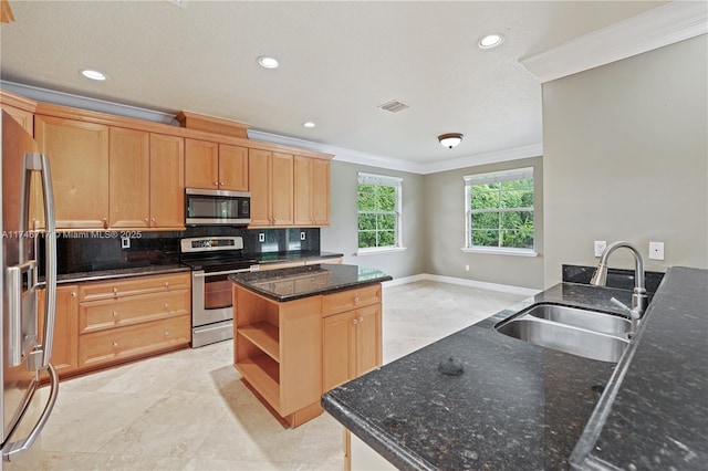 kitchen with a center island, crown molding, open shelves, appliances with stainless steel finishes, and a sink