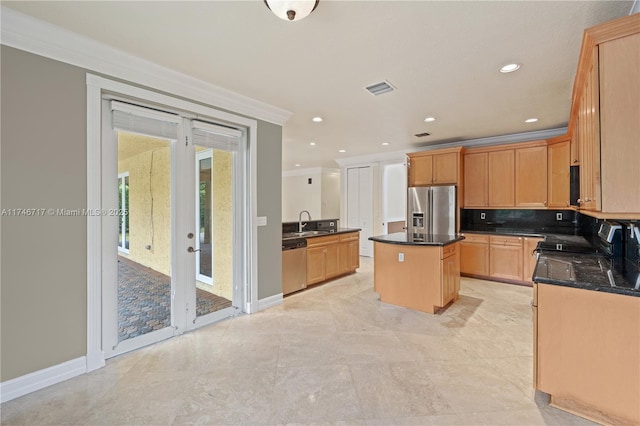 kitchen featuring stainless steel appliances, a sink, a kitchen island, visible vents, and ornamental molding