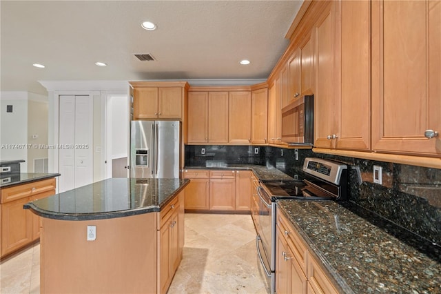 kitchen with stainless steel appliances, a kitchen island, visible vents, decorative backsplash, and dark stone counters