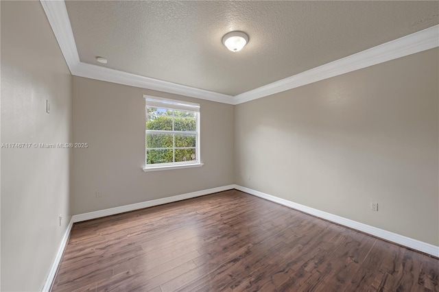 unfurnished room with baseboards, dark wood-type flooring, and crown molding