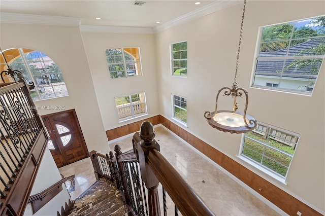 foyer entrance featuring recessed lighting, a healthy amount of sunlight, and crown molding